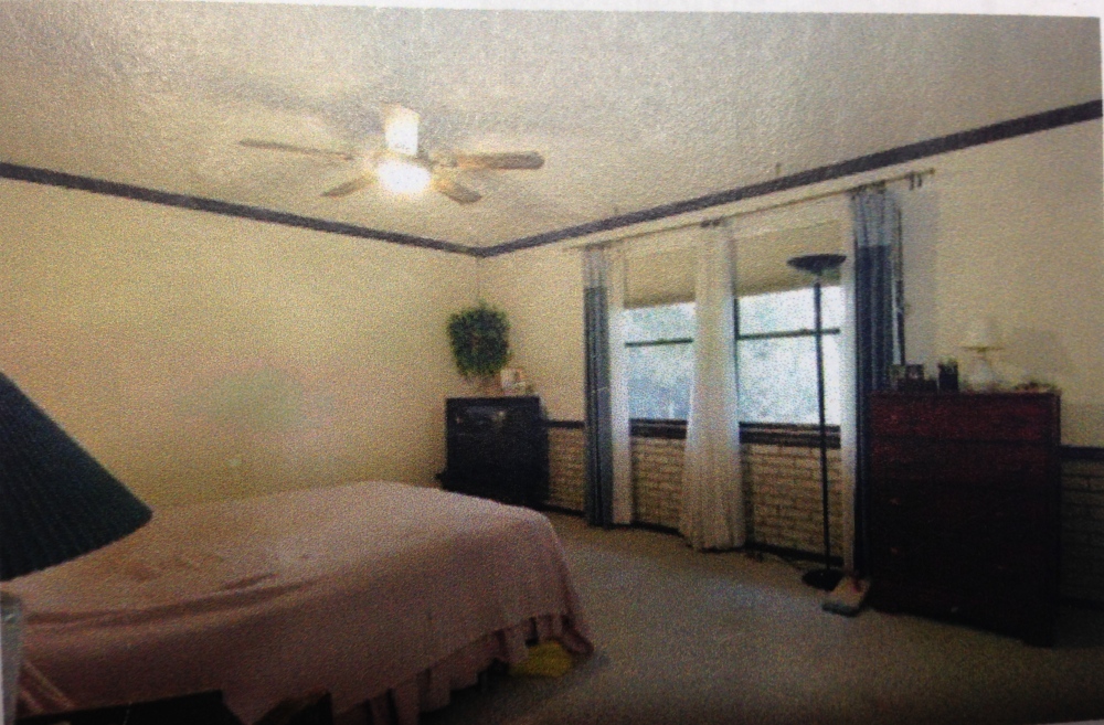 This photo was taken with the previous owners of the house. You can see the dark wood trim everywhere, cream walls, and ugly brick.